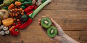 A vibrant spread of fresh fruits and vegetables rich in potassium on a wooden table.