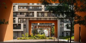 Modern intergenerational housing complex with accessible garden space.