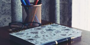 A quiet, inviting desk space with a notebook and pen, representing the start of a storytelling journey.