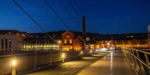 A modern, well-lit pedestrian walkway at twilight designed for safety and comfort.