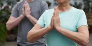 An older adult practicing gentle wrist mobility exercises in a comfortable home setting.