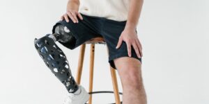 An older adult performing seated knee-extensions to maintain leg strength.