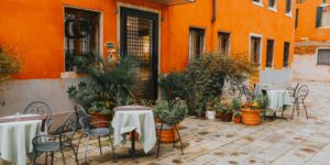 A welcoming, accessible cafe in a historic plaza setting with comfortable seating and flat terrain.