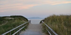 Senior couple enjoying an accessible coastal boardwalk at sunset.