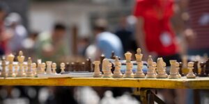 A wooden chess set in a bright, welcoming community space, representing the social and mental benefits of chess for older adults.