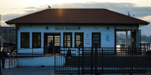 A serene, accessible coastal ferry terminal building at sunrise.