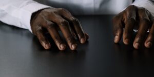 Close-up of hands resting on a table, prepared for dexterity exercises.