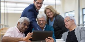 A group of seniors and younger community members collaborating on a local history project.