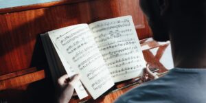 A peaceful study room with music scores and a piano, representing the joy of learning music.