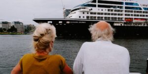 An active senior couple enjoying the view from a cruise ship deck.