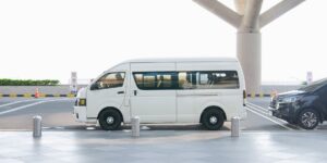 A sleek airport electric shuttle parked in a modern terminal, ready for passengers.
