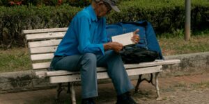 An older adult performing a seated chin-tuck for better posture.