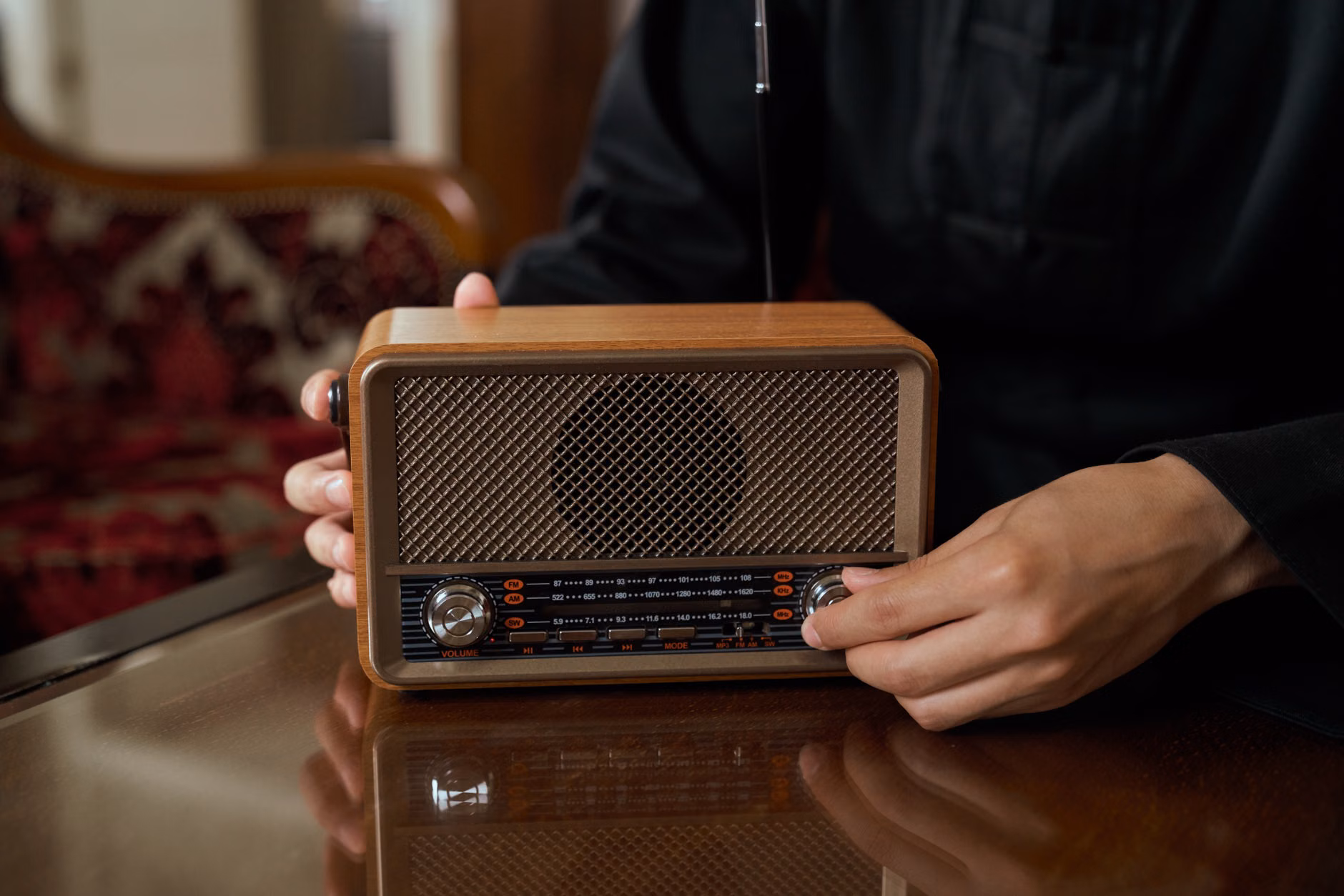 Amateur Radio: A Cognitive and Social Hobby for the Modern Senior 1 Close-up of hands adjusting a radio dial.