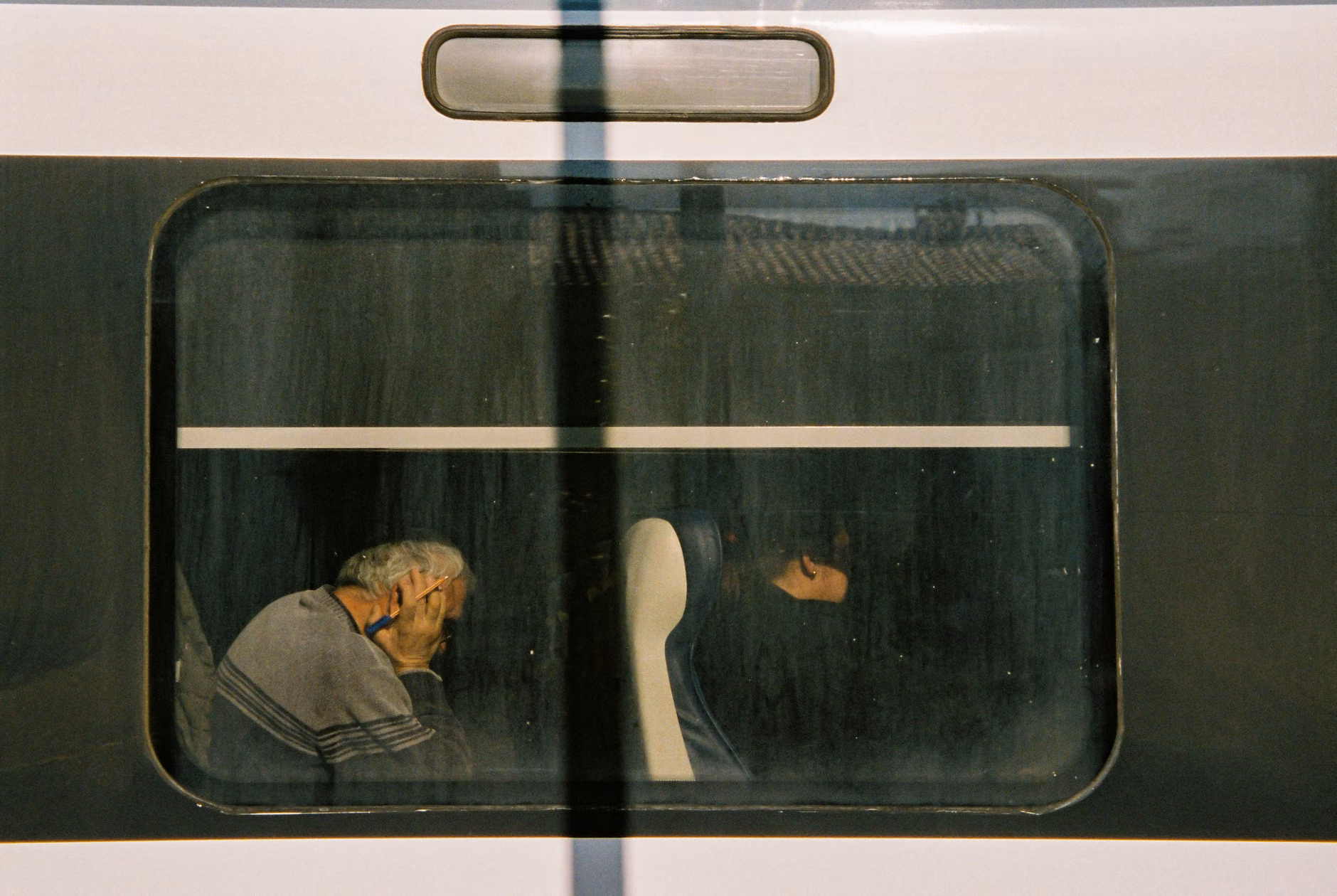 Senior traveler sitting inside a spacious funicular carriage.