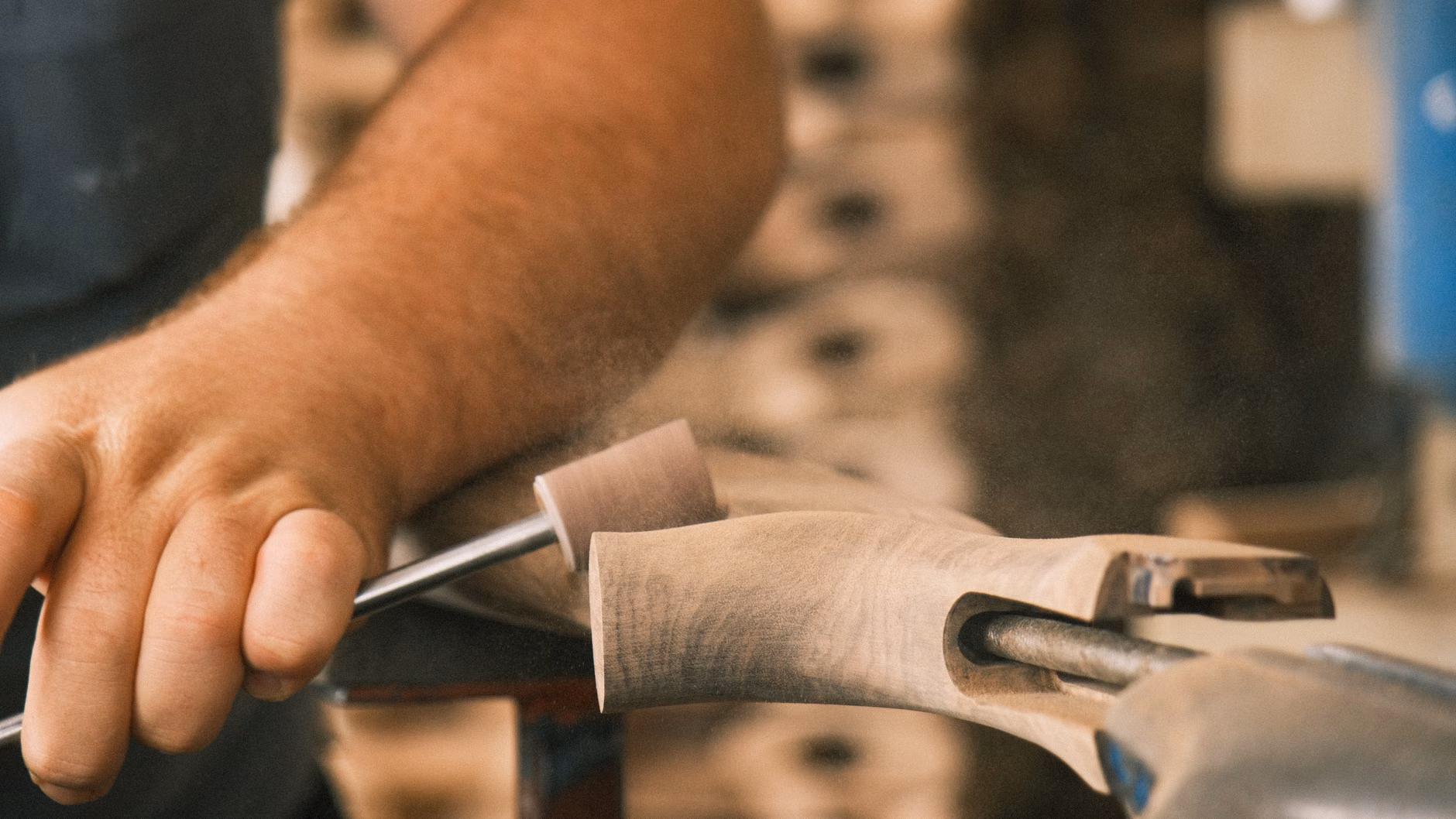 The Community Woodcarving Advantage: Social Connection and Cognitive Vitality 1 Close-up of hands using a wood carving tool on a piece of wood.