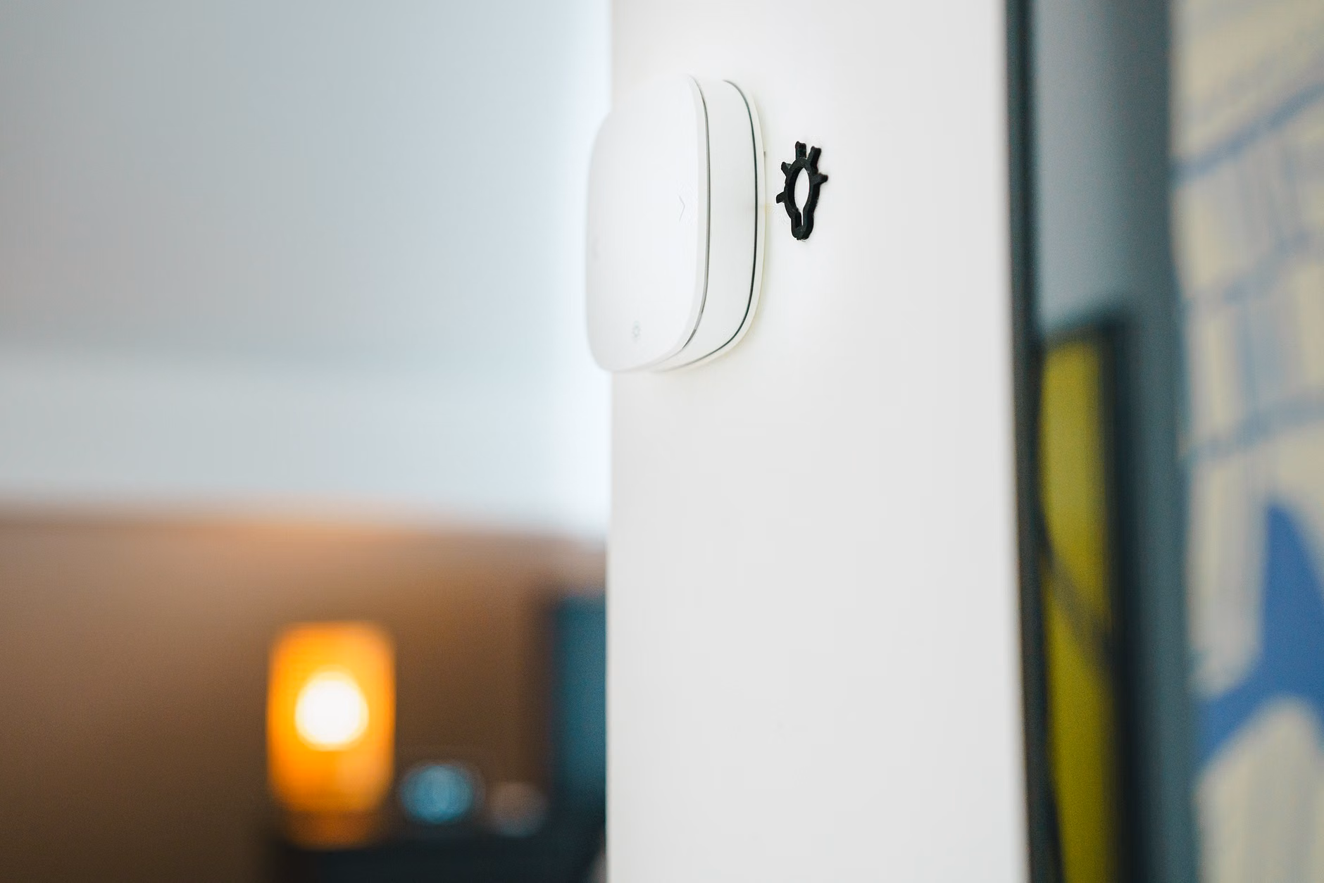Close-up of a modern smart thermostat mounted on a wall.