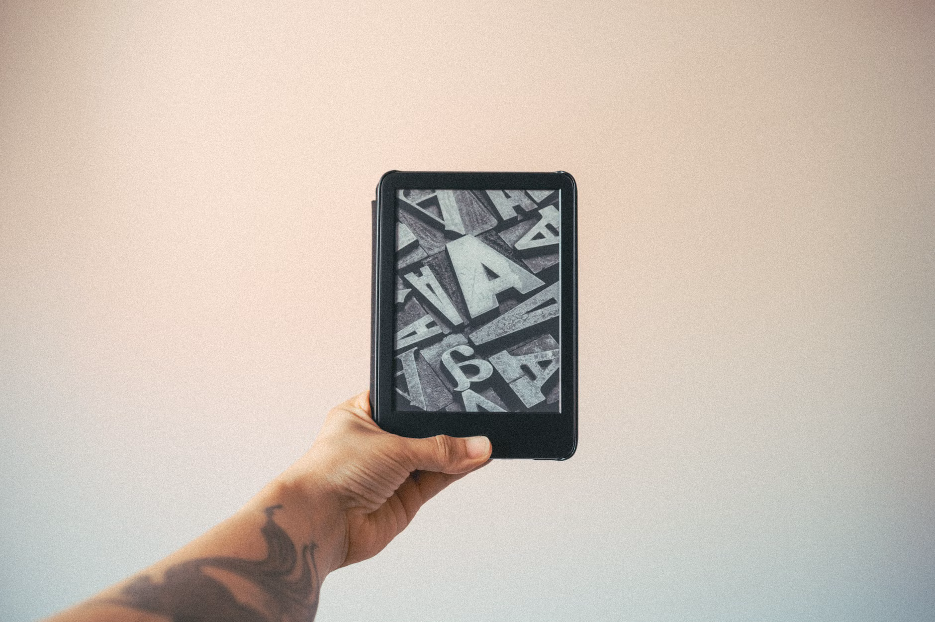 Hands holding an e-reader with large, accessible text.