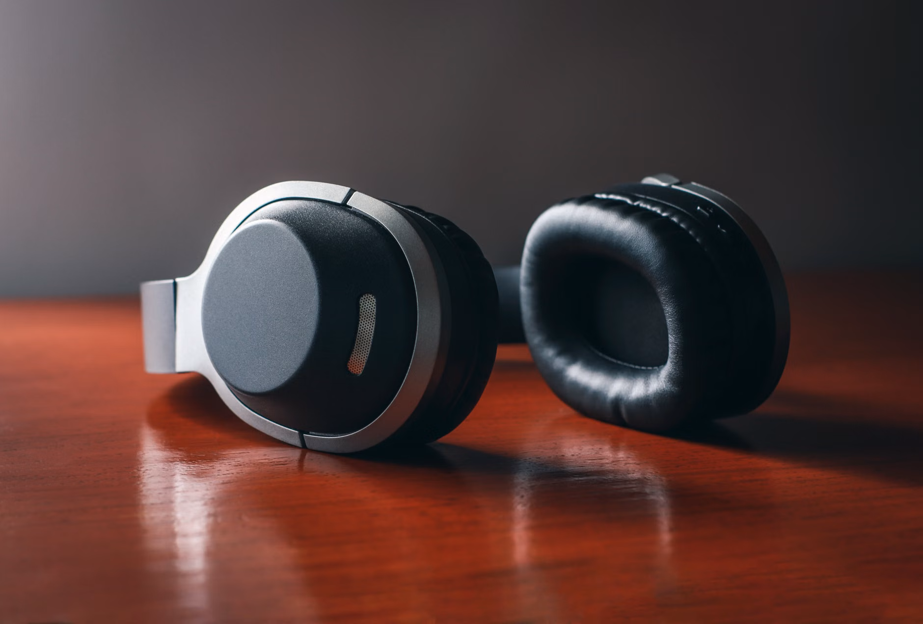 Noise-canceling headphones with travel documents on a table.