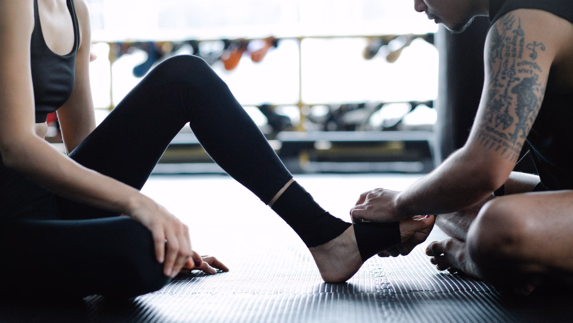 Correct seated posture for performing ankle mobility exercises.