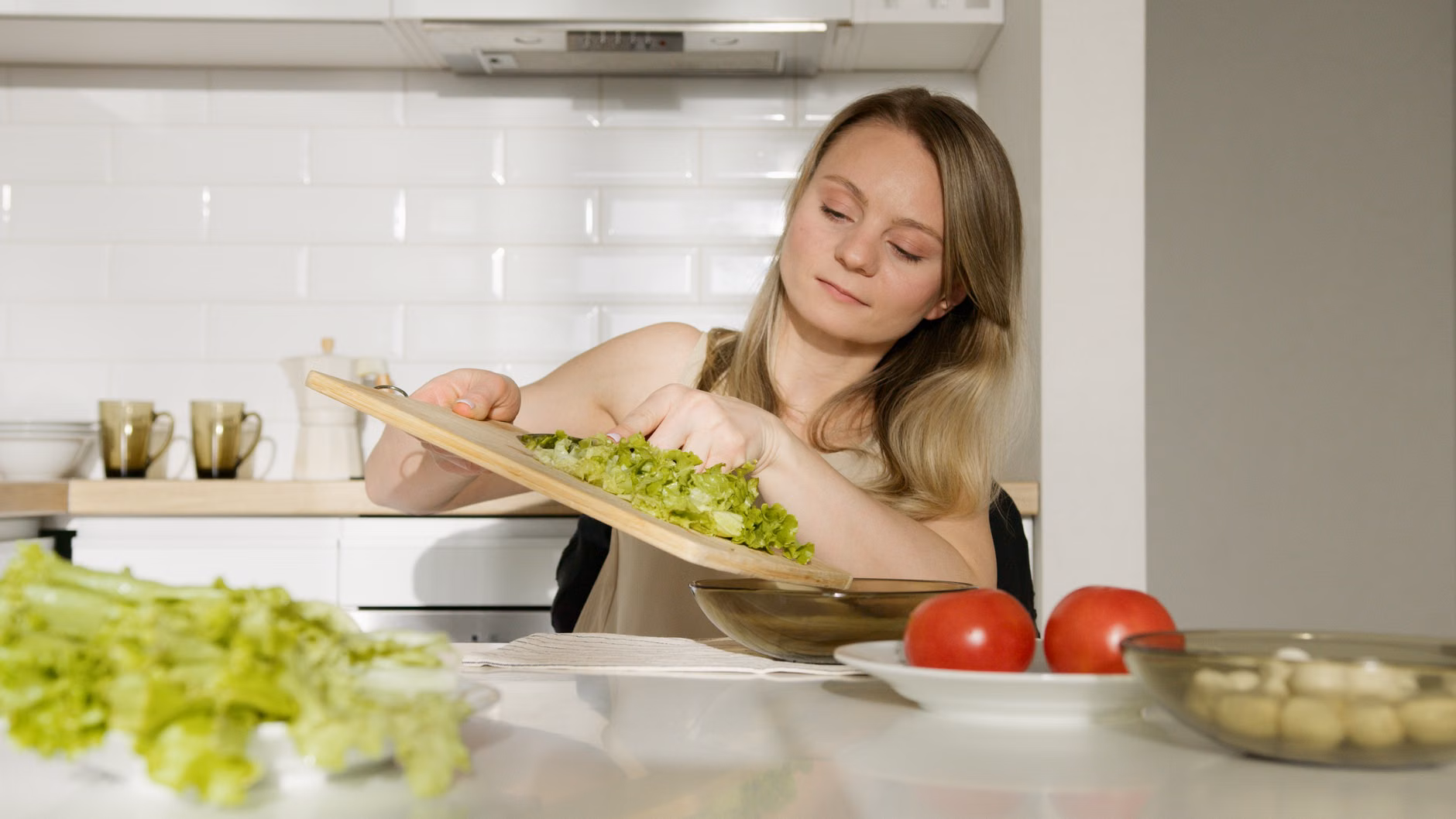 An older adult preparing a nutrient-dense meal in a home kitchen.