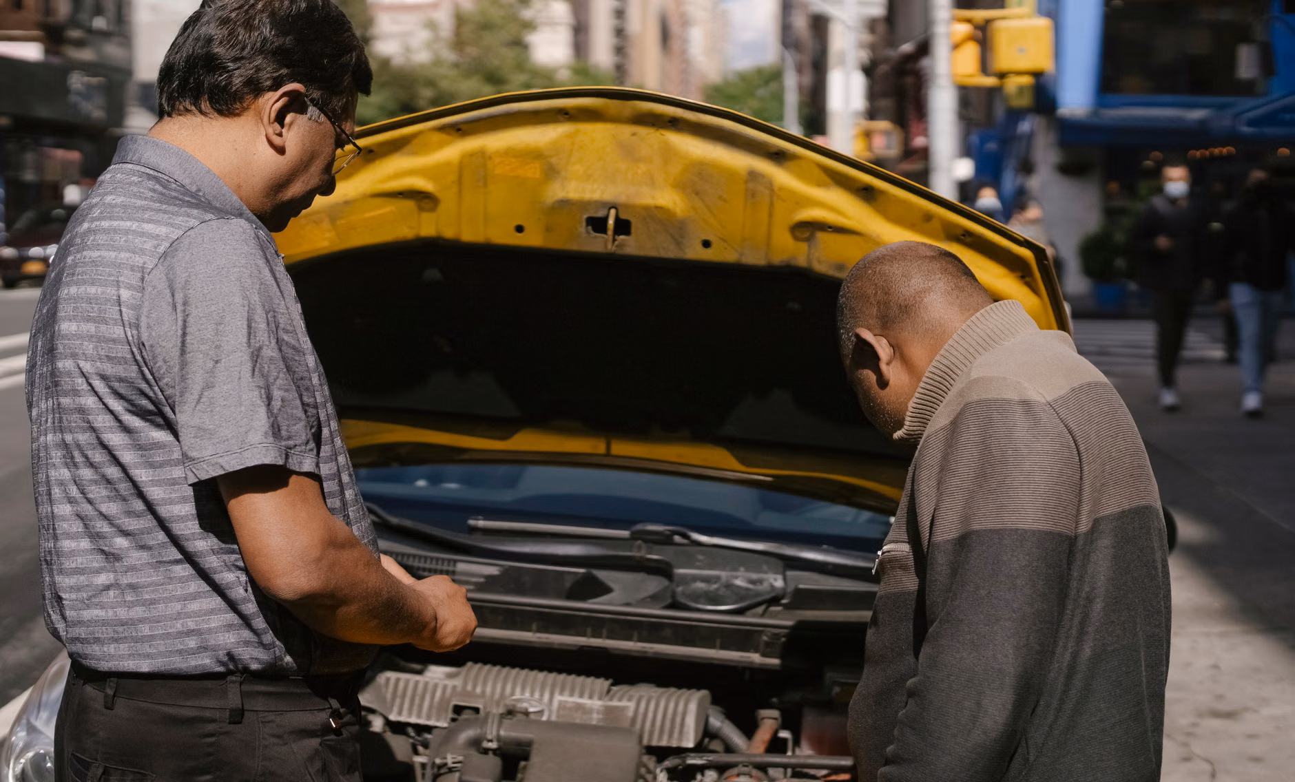 A senior interacting with a local technician in a repair shop.