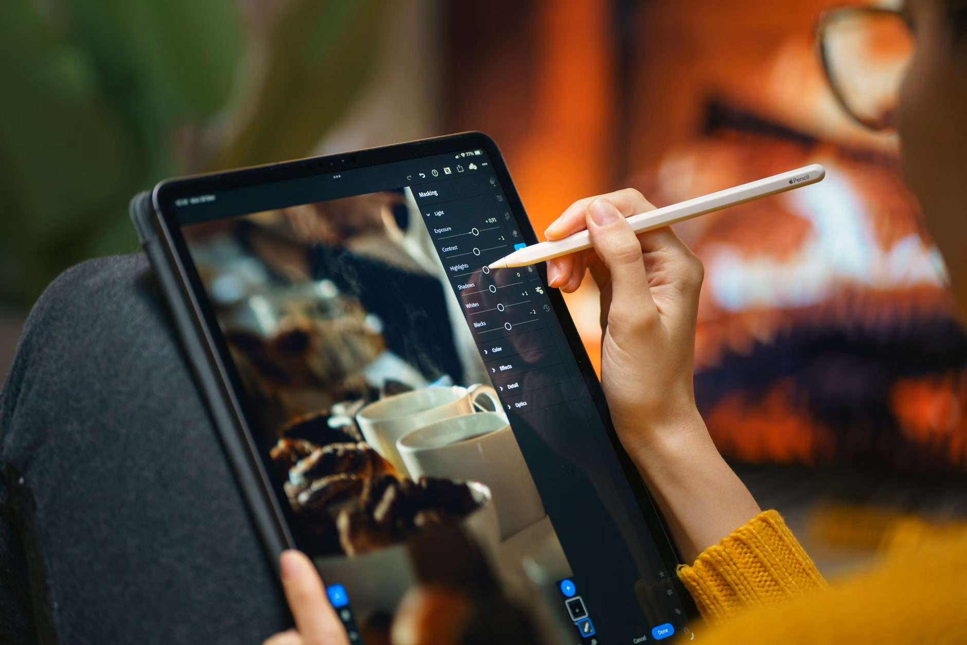 An older adult learning digital photo editing on a tablet.