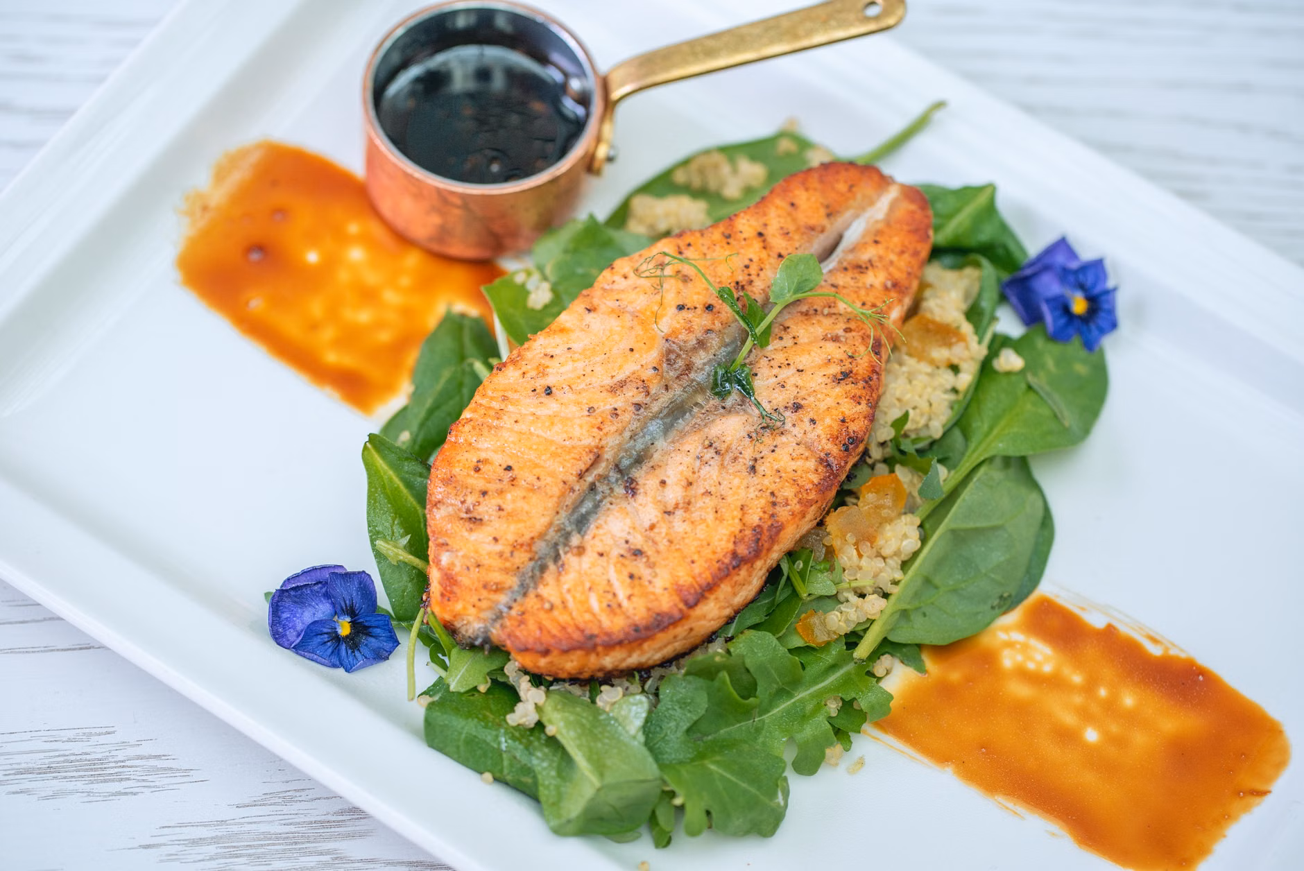 Zinc for Immune Resilience: A Practical Guide for Healthy Aging 2 A balanced plate of salmon, spinach, and quinoa for a healthy senior diet.