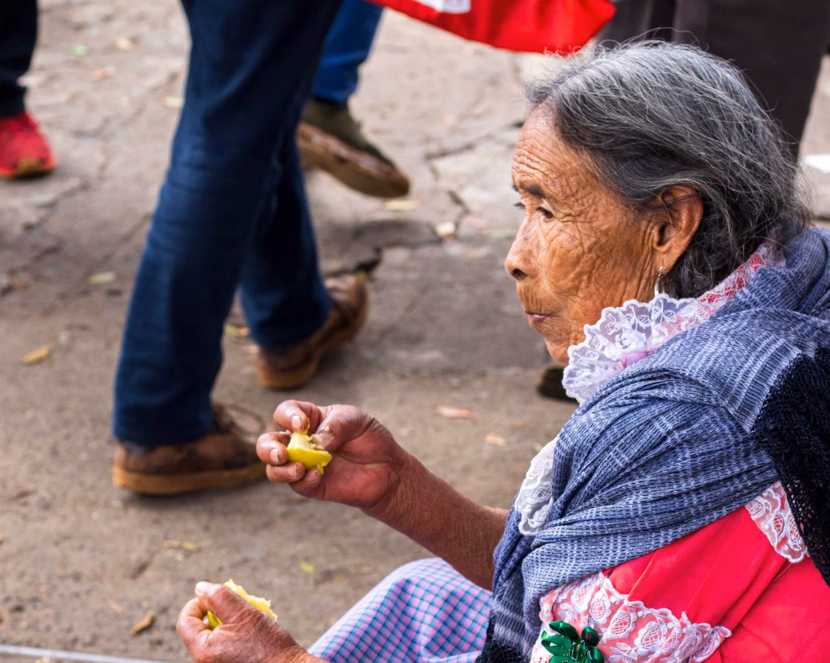 An older adult carefully reviewing nutritional information on a food product.