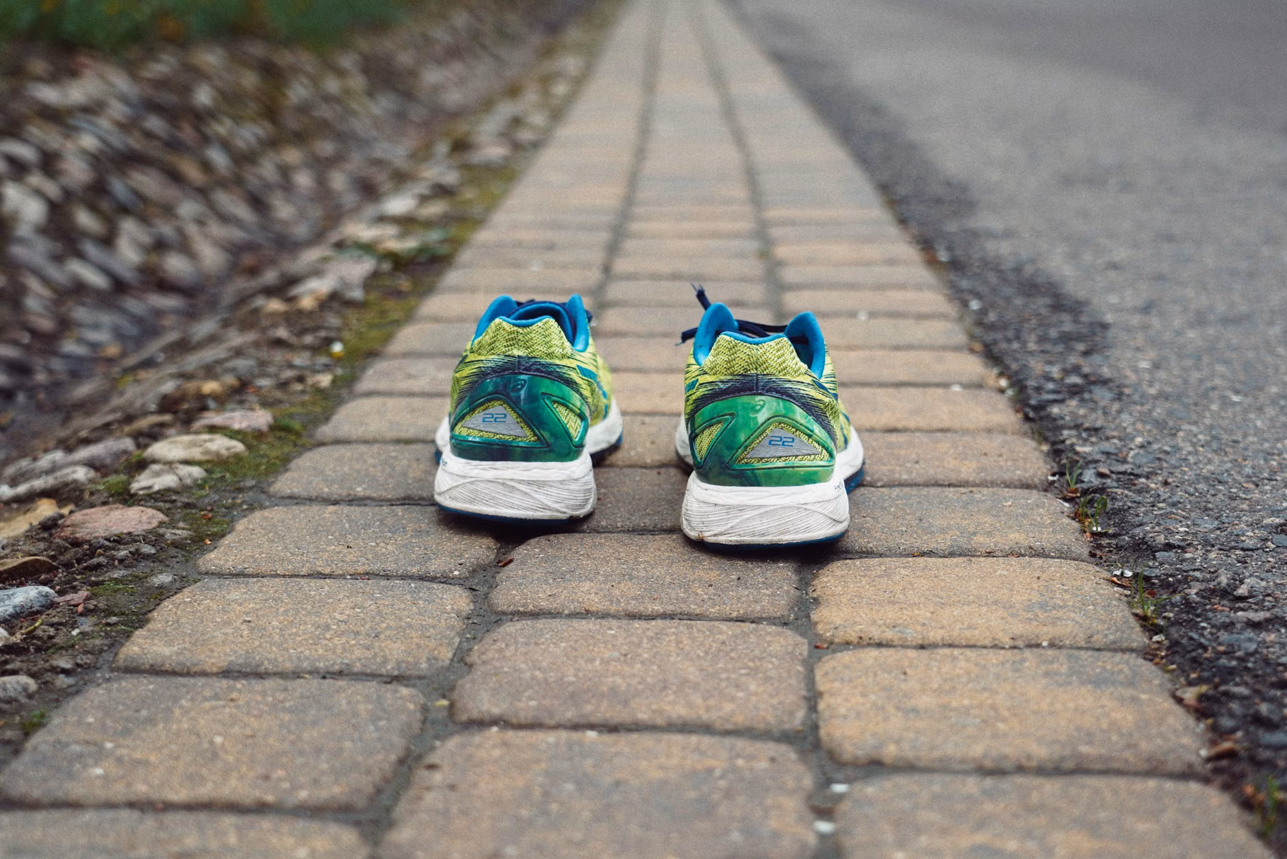 Supportive walking shoes on a cobblestone path.