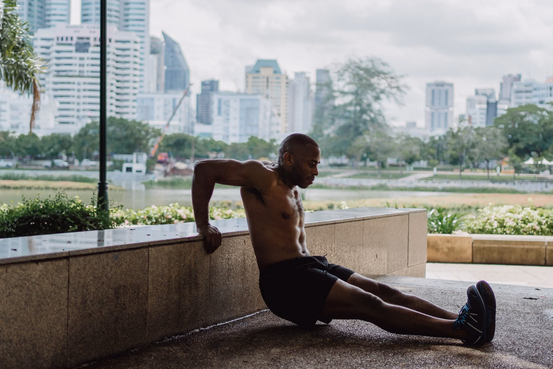 Proper form for a seated triceps dip showing spinal alignment and arm positioning.