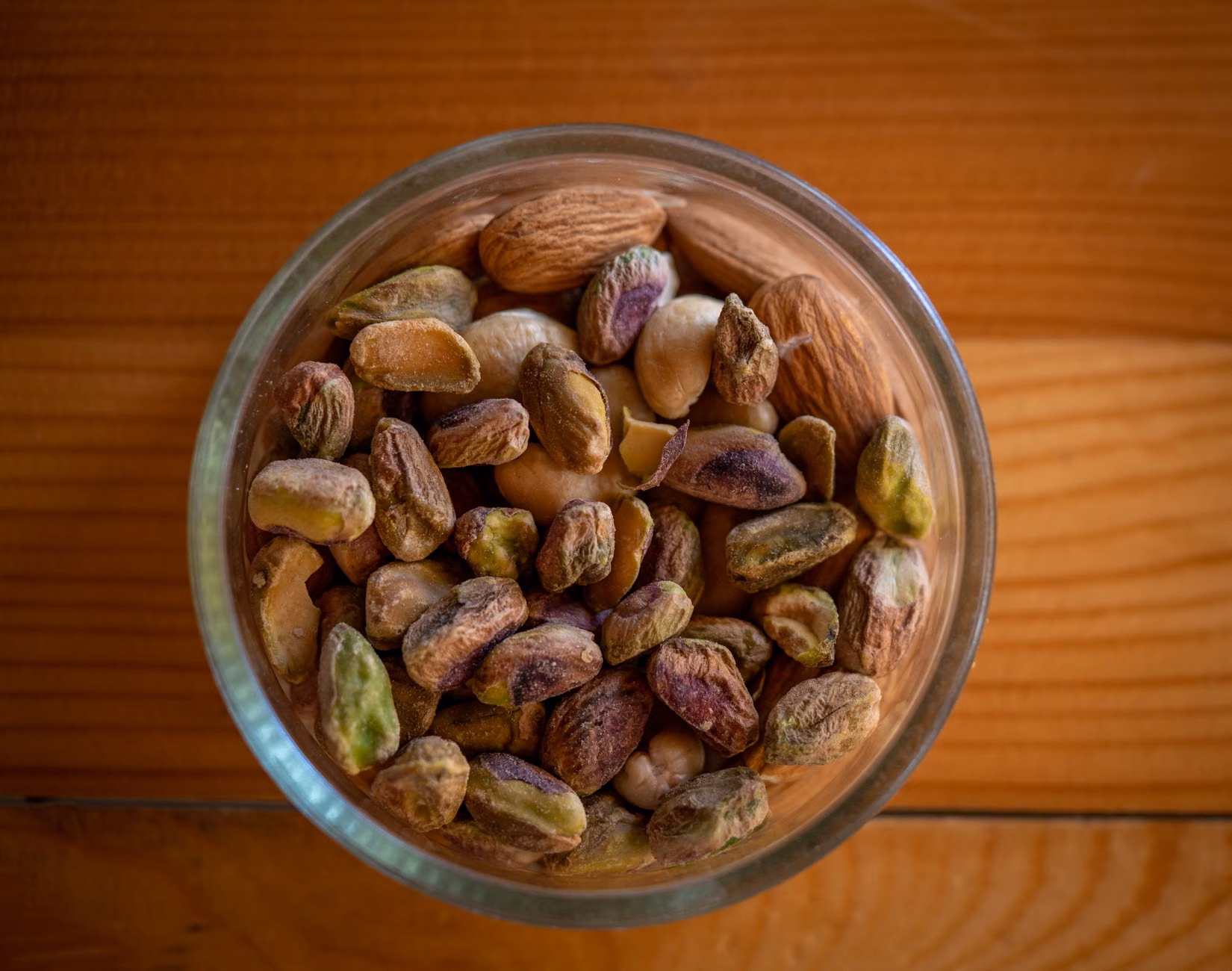Magnesium for Nerve and Muscle Function: A Practical Guide for Adults 60+ 2 A close-up of a variety of nuts and seeds in a wooden bowl.