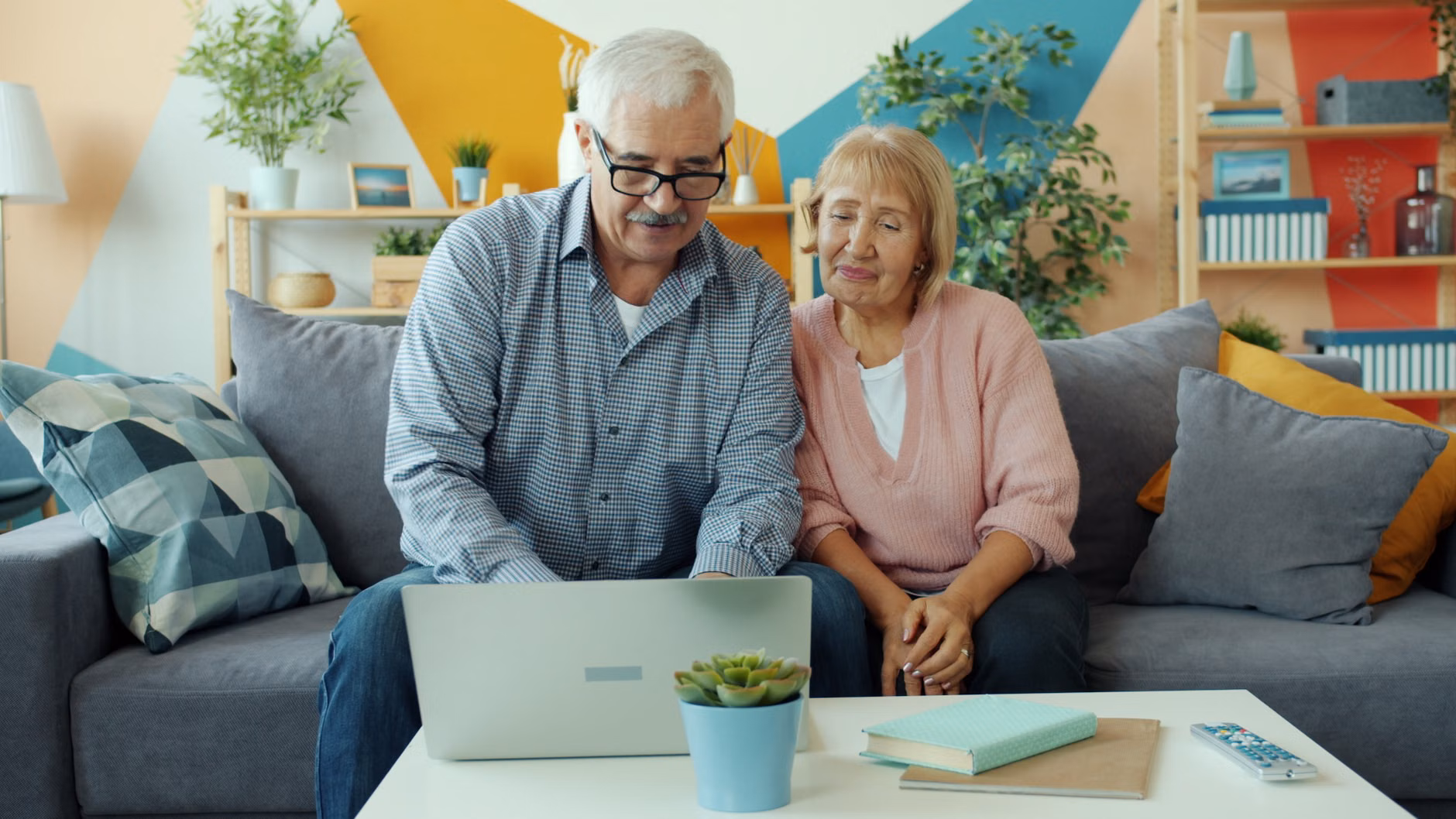 An older couple reviewing health information on a laptop together.