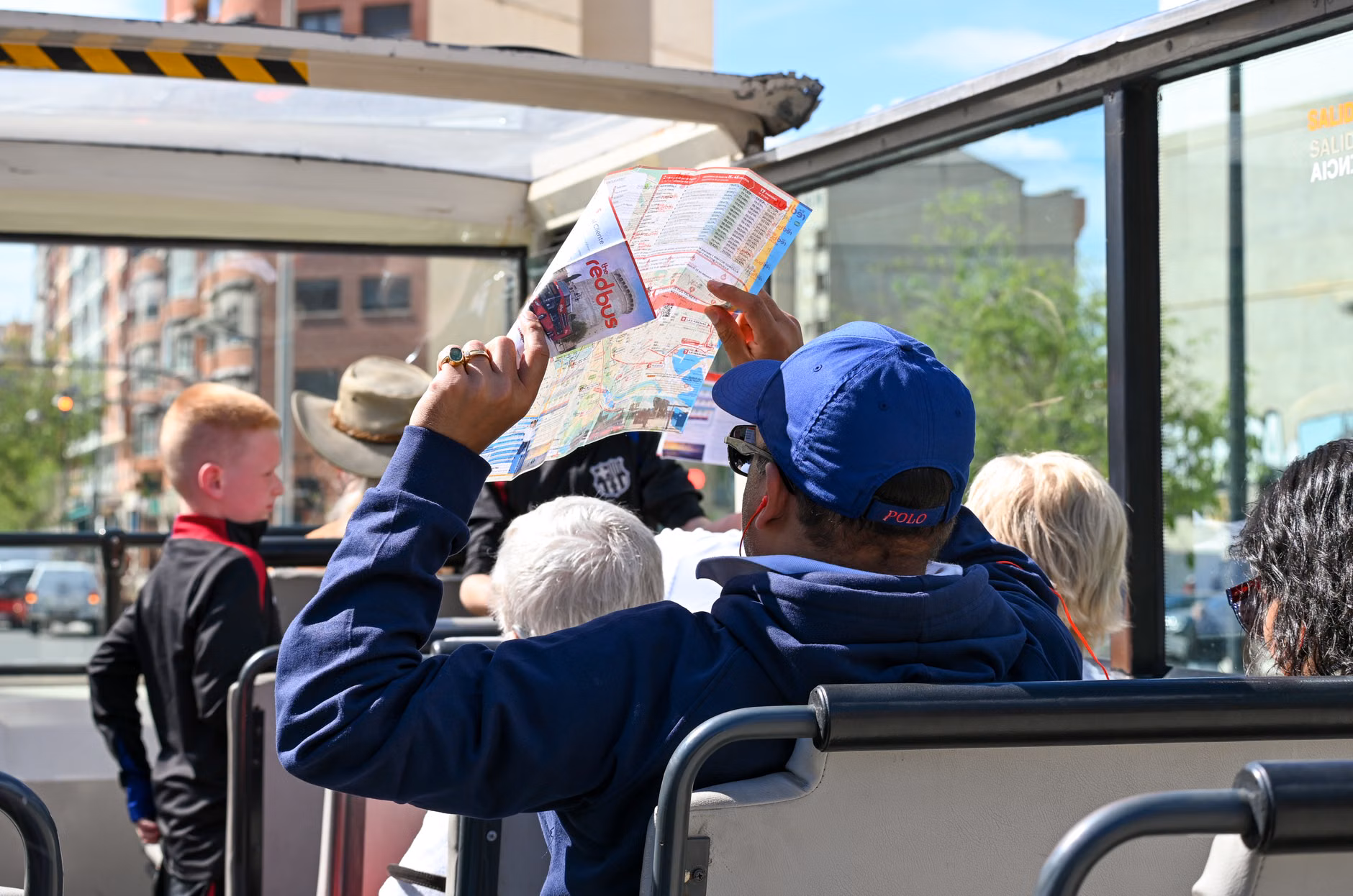 A tour guide leading a group of seniors on a flat, accessible path.