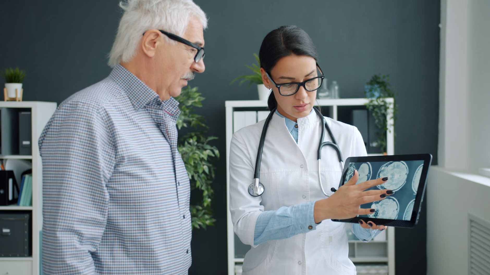 A senior patient discussing health markers with a physician.