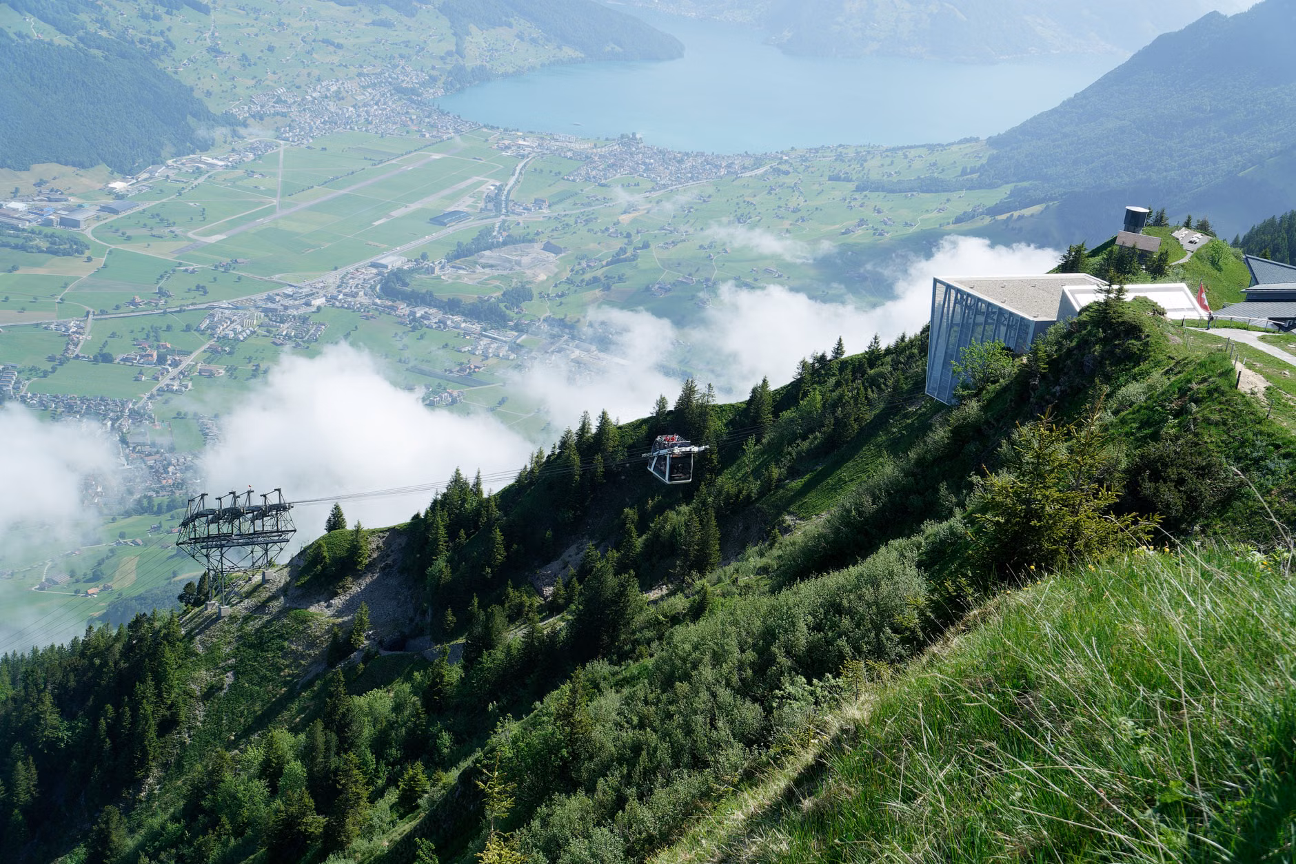 Two seniors looking at a view from a funicular observation deck.