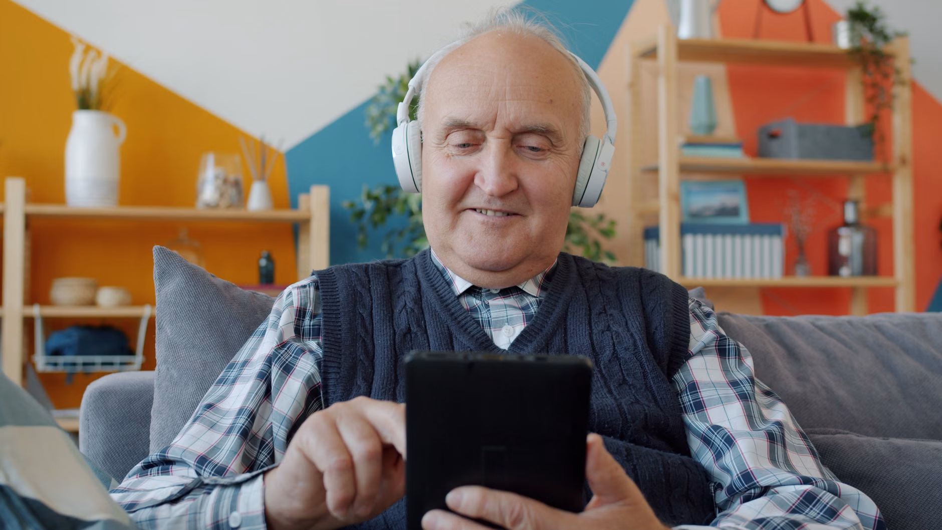 An older adult using a museum audio guide for an enhanced sensory experience.