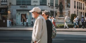 Senior couple walking in a smart city plaza with wearable technology.