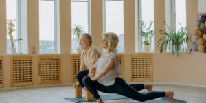 A senior person performing a gentle seated calf stretch in a comfortable home environment.