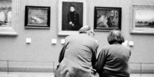 An active senior couple exploring a modern, accessible museum gallery.