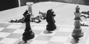 A classic wooden chess set bathed in natural sunlight.