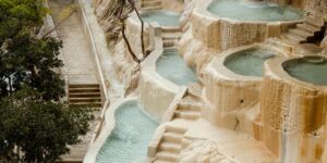 An accessible hot spring resort featuring a ramp entry and natural surroundings.