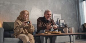 A senior couple using voice-controlled smart home technology in a bright, modern living room.