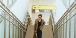 A modern, accessible airport terminal with a senior traveler navigating the space comfortably.