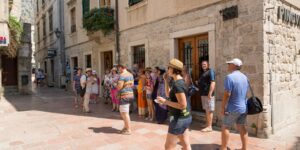 A group of active seniors enjoying a guided walking tour in a historic city.