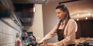 An active senior preparing a healthy meal in a bright kitchen.