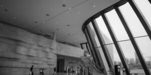 A sophisticated senior traveler in a modern museum lobby.