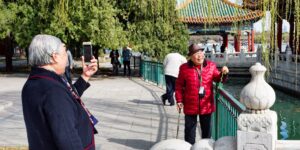 A group of active seniors enjoying a photography outing in a park.