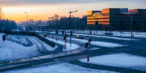 Modern city street with warm, even lighting at dusk.