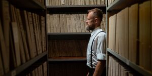 An older adult researching local history in an archive library.