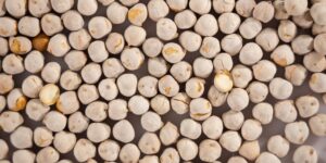 A selection of thiamin-rich whole foods like grains and legumes on a wooden table.
